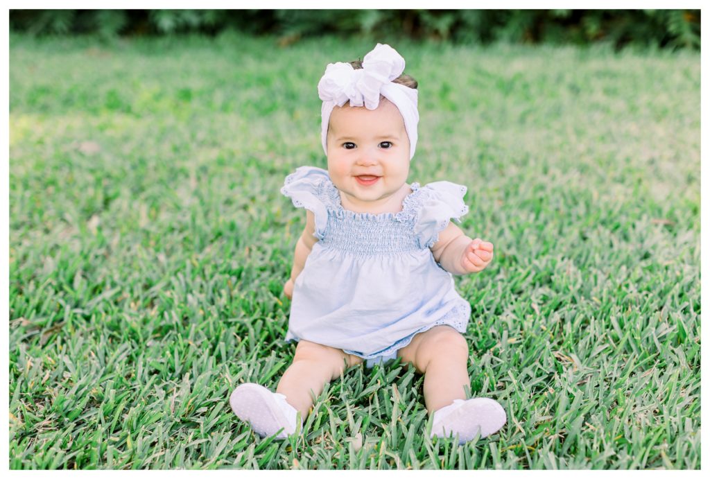 6 month old baby girl milestone photos in the grass in Tampa FL
